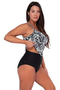 Side pose #1 of Nicki wearing Sunsets Caribbean Seagrass Texture Taylor Tankini Top lifted to show matching Hannah High Waist bikini bottom
