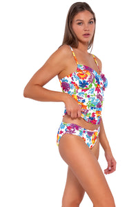 Side pose #1 of Daria wearing Sunsets Camilla Flora Simone Tankini Top lifted to show matching Audra Hipster bikini bottom