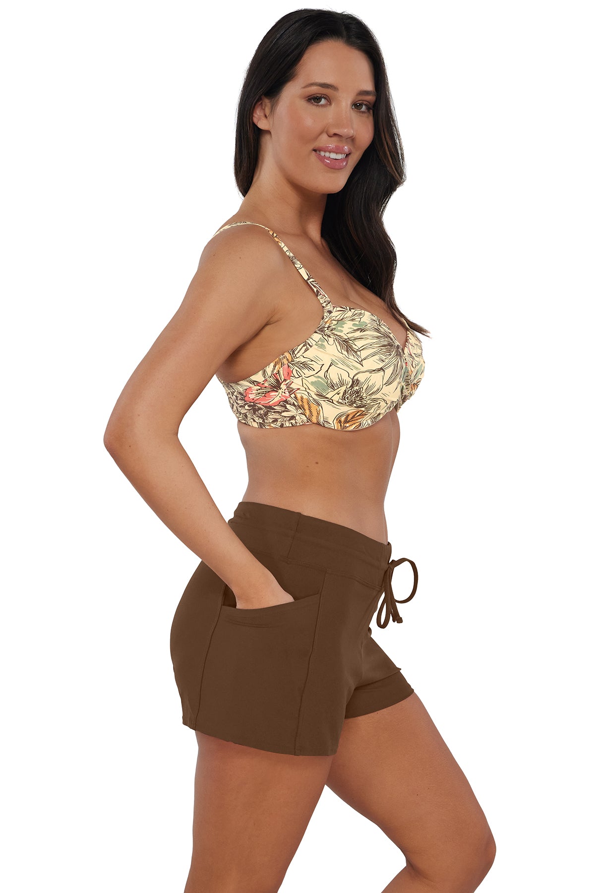 Quarter pose #1 of Nicki wearing Sunsets Escape Tiki Brown Laguna Swim Short with hand in pocket