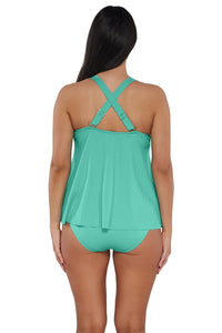 Back pose #1 of Nicki wearing Sunsets Escape Aqua Mist Sandbar Rib Sadie Tankini Top