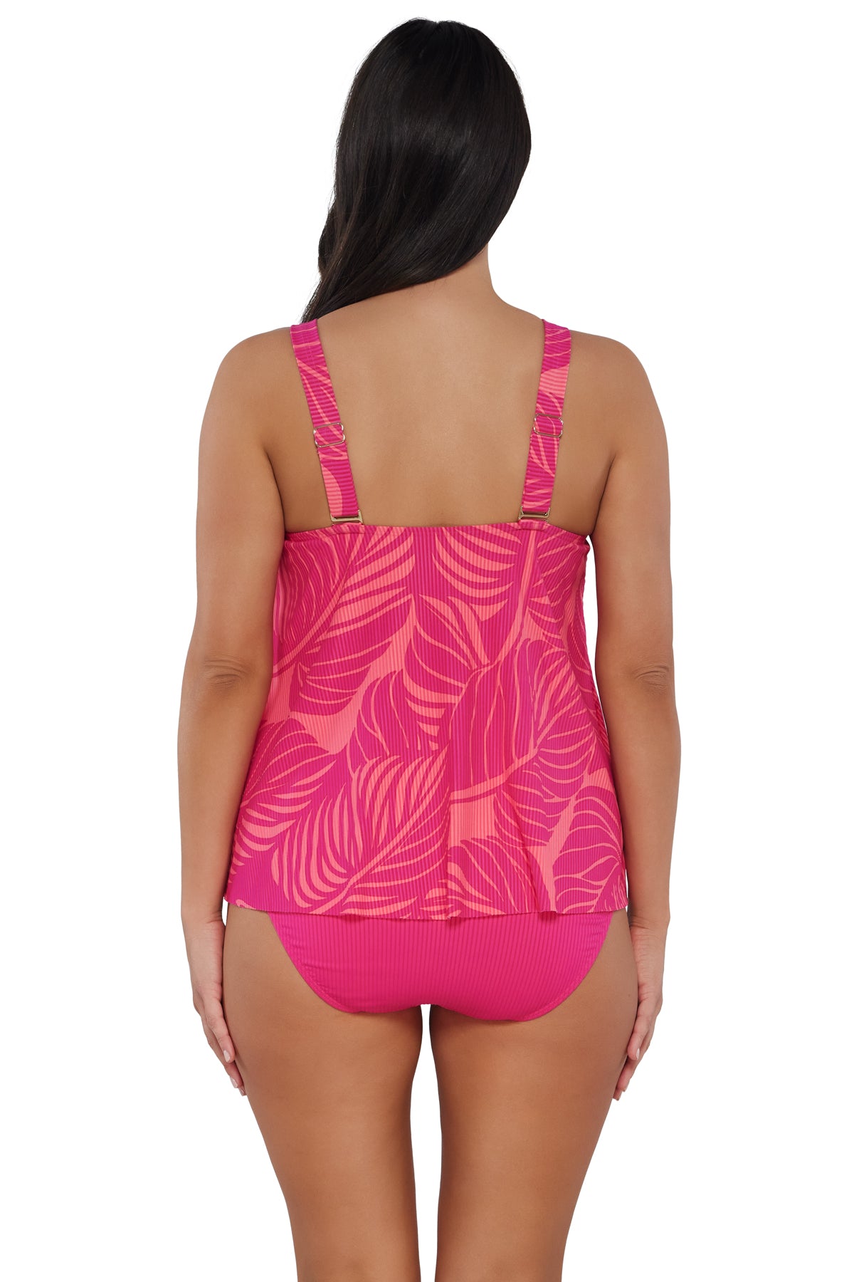 Back pose #1 of Nicki wearing Sunsets Escape Blushing Palms Sandbar Rib Sadie Tankini Top