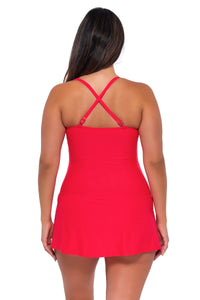 Back pose #1 of Nicky wearing Sunsets Escape Geranium Sienna Swim Dress showing crossback straps