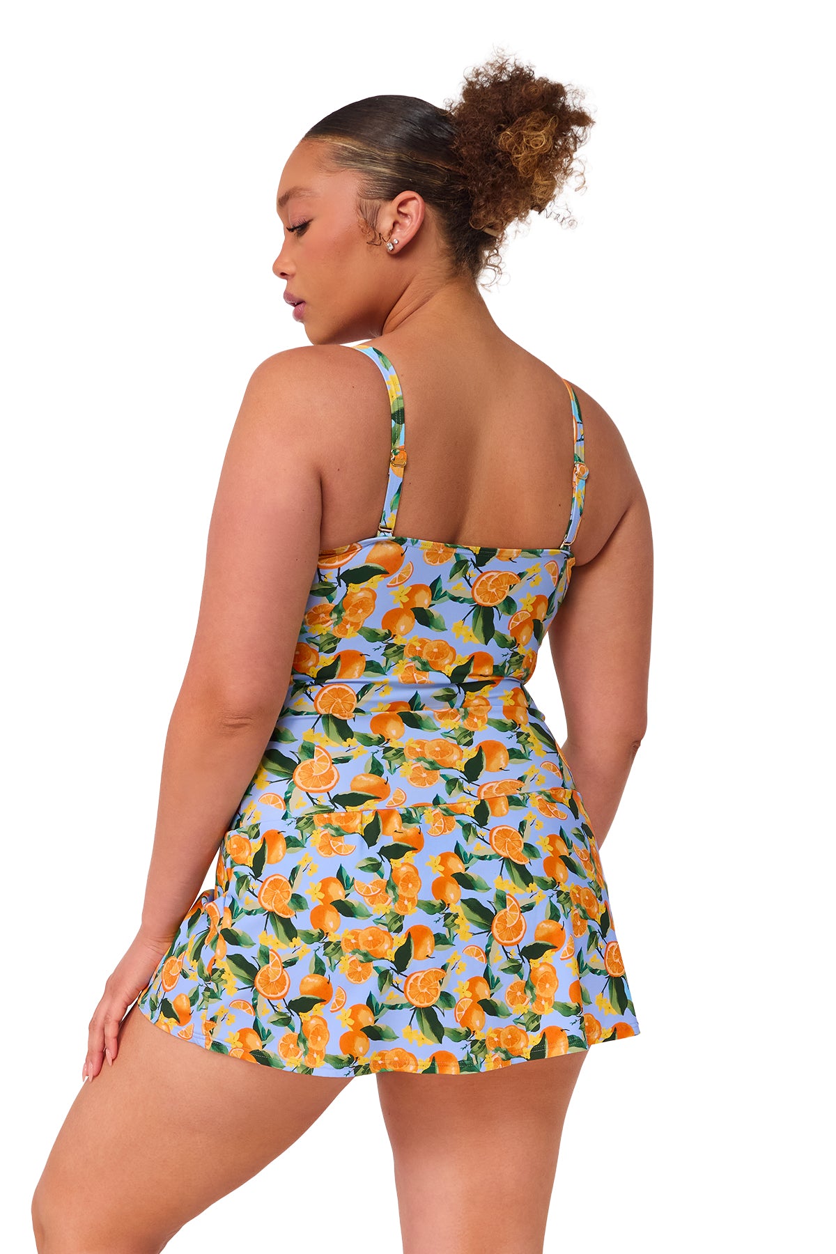 Oblique pose #1 of Haviland wearing Sunsets Escape Clementine Sienna Swim Dress