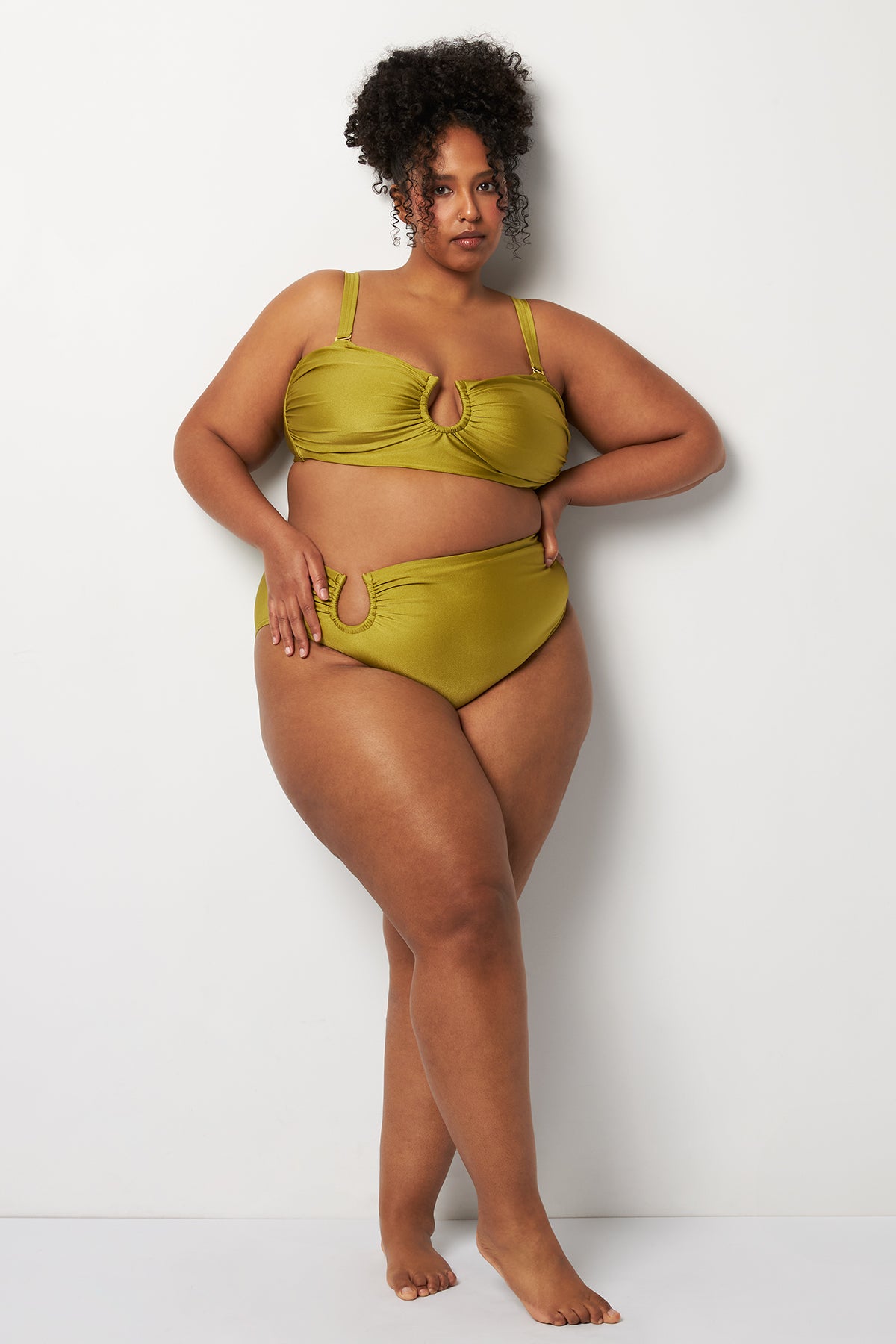 Side pose #1 of Lydia wearing Villa Fresca Shiny Olive Sofia Bikini Bottom paired with