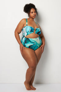 Side pose #1 of Lydia wearing Villa Fresca Tropic Ink Isla One-Piece