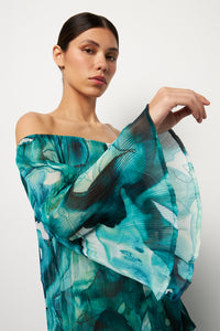 Side pose #1 of Alexa wearing Villa Fresca Tropic Ink Malia Pleated Dress Cover-Up