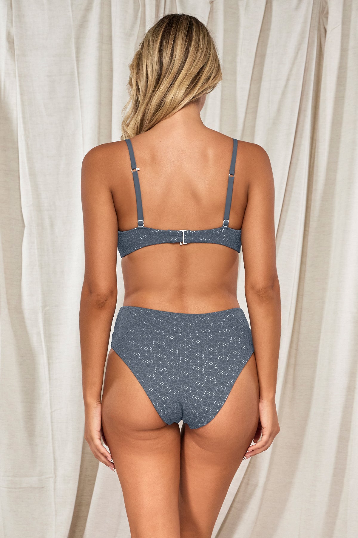 Back pose #1 of Jessica wearing Swim Systems Dusk Daisy Eyelet Delfina V Front Bottom paired with matching Pom Pom Annalee Underwire Bikini Top