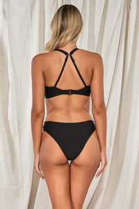 Back pose #1 of Jessica wearing Swim Systems Black Paige Top showing crossback straps