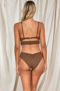 Back pose #1 of Jessica wearing Swim Systems Cocoa Daisy Eyelet Kaia Top paired with matching Hazel Hipster Bikini Bottom