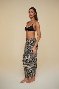 Quarter pose #1 of Jaida wearing B Swim  Miyajima Caspian Cover-Up as a skirt paired with Black Depth Meridian Underwire Top