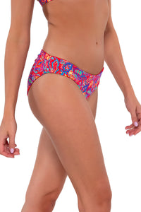 Side pose #2 of Daria wearing Sunsets Rue Paisley Alana Reversible Hipster Bottom
