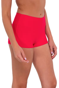 Side pose #1 of Daria wearing Sunsets Geranium Kinsley Swim Short