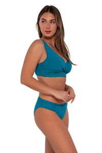 Side pose #2 of Taylor wearing Sunsets Avalon Teal Elsie Top paired with Audra Hipster bikini bottom