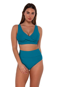 Front pose #2 of Taylor wearing Sunsets Avalon Teal Hannah High Waist Bottom paired with Elsie Top bikini bralette