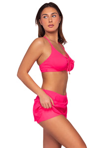 Side view of Sunsets Neon Pink Sporty Swim Skirt  lifted up to show attached swim short with Kauai Keyhole bikini top
