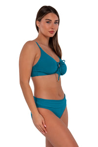 Side pose #1 of Taylor wearing Sunsets Avalon Teal Unforgettable Bottom paired with Kauai Keyhole bikini top