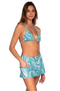 Side view of Sunsets Moon Tide Sporty Swim Skirt with hand in pocket and with matching Laney Triangle bikini top