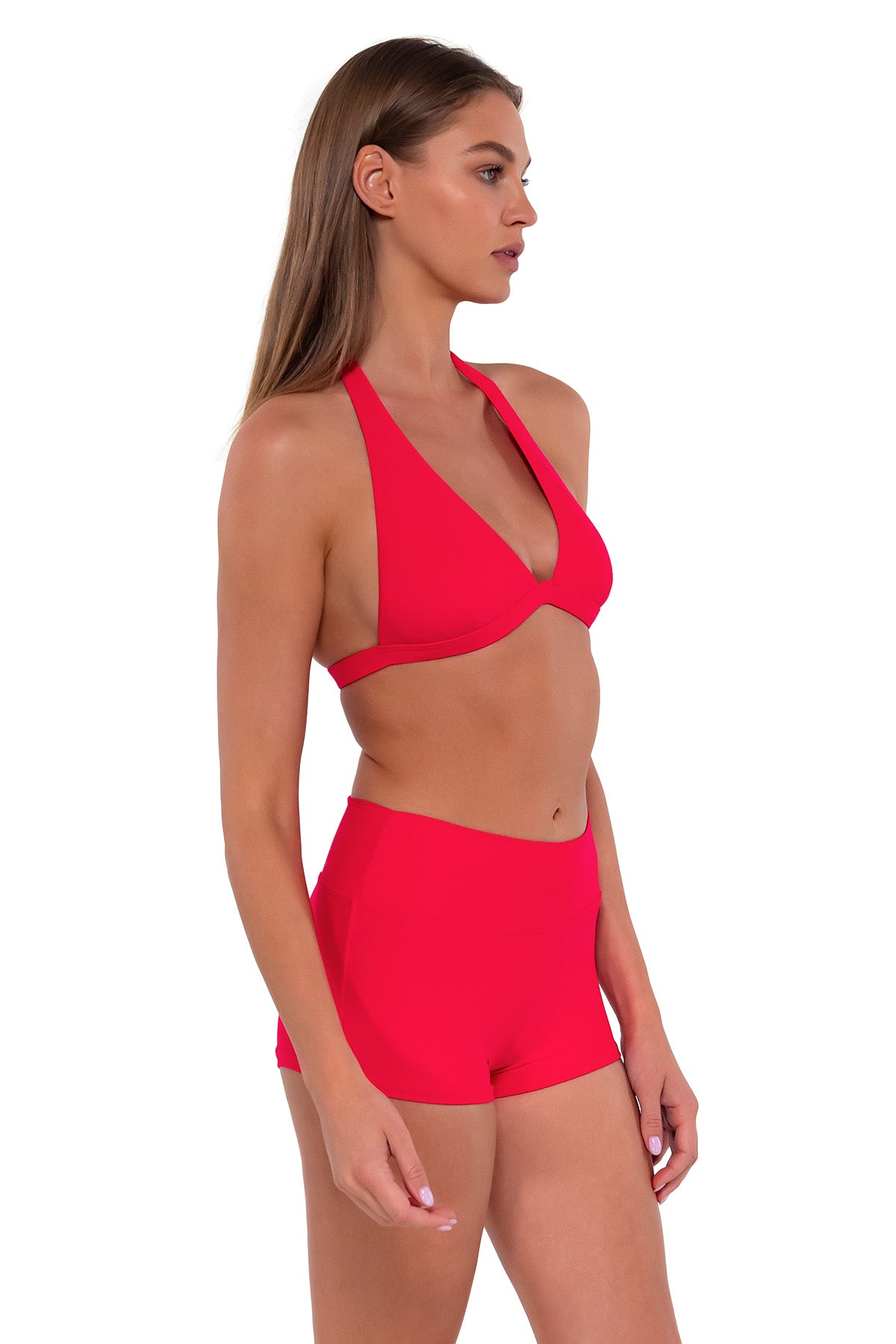Side pose #1 of Daria wearing Sunsets Geranium Kinsley Swim Short with matching Faith Halter bikini top