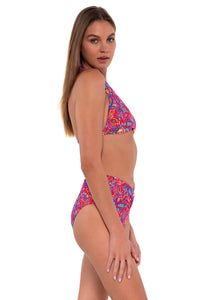 Side pose #1 of Daria wearing Sunsets Rue Paisley Summer Lovin' V-Front Bottom with matching Faith Halter bikini top