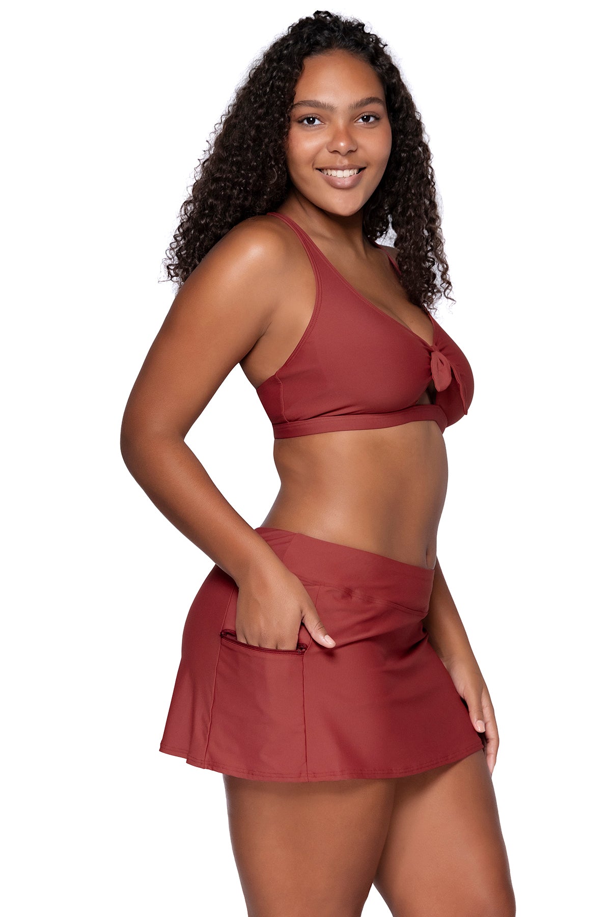 Side view of Sunsets Tuscan Red Sporty Swim Skirt with hand in pocket and with matching Brandi Bralette bikini top