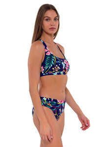 Side pose #1 of Daria wearing Sunsets Island Getaway Unforgettable Bottom with matching Brandi Bralette bikini top
