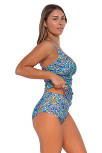 Side pose #1 of Taylor wearing Sunsets Pansy Fields Zuri V-Wire Tankini Top lifted up to show matching Hannah High Waist bikini bottom