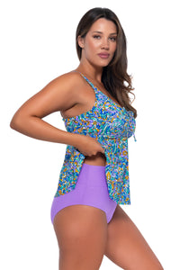 Side pose #1 of Nicky wearing Sunsets Escape Pansy Fields Marin Tankini Top lifted up to show matching Hannah High Waist bikini bottom