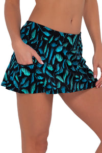 Side pose #2 of Gigi wearing Sunsets Cascade Seagrass Texture Sporty Swim Skirt with hand in pocket