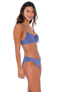 Side pose #1 of Chonzie wearing Swim Systems Blue Iris Chloe Bottom with matching Avila Underwire bikini top