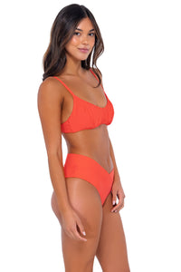Side pose #1 of Chonzie wearing Swim Systems Tangelo Bonnie Top with matching Delfina V Front bikini bottom