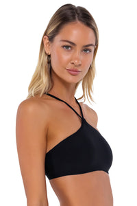 Side pose #1 of Jessica wearing Swim Systems Black Roya Top
