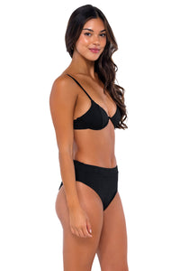 Side pose #1 of Chonzie wearing B Swim Black Baja Rib Margot Bottom with matching Macie bikini top