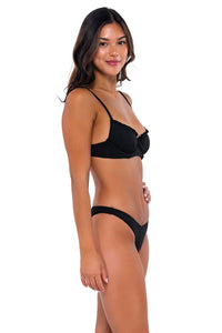 Side pose #1 of Chonzie wearing B Swim Black Baja Rib Carly Bottom with matching Lyra bikini top